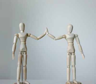 Blurred motion of a person transitioning between two strength poses.