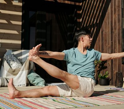 Man holding a difficult balance pose on one leg.